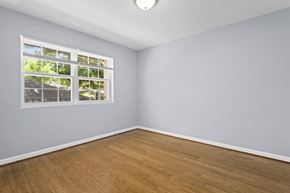 Washington apartment for rent - an empty room with hardwood floors and a large window